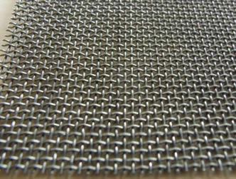 A piece of monel coarse woven wire mesh on the ground.