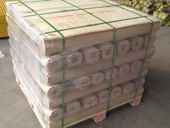 Several rolls of monel woven wire meshes are packed by a pallet and green packing belt.