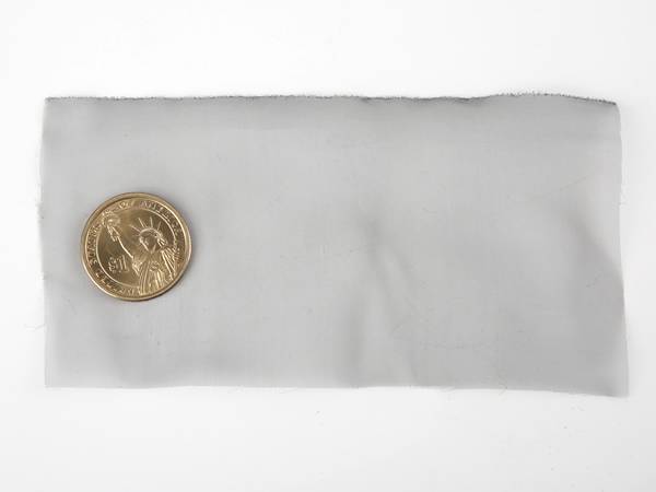 A piece of blacked stainless steel shielding mesh on white background.