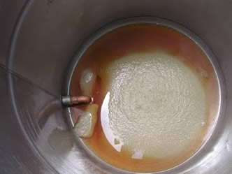 A mash tun with several liquid in it.