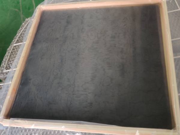 Place cut squares of blackened stainless steel shielding mesh on the table top