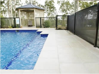 A corner of swimming pool fence made of crime safe mesh.