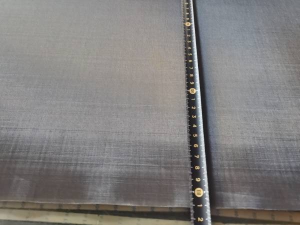 Measure blackened copper mesh width with tape measure