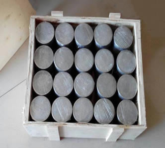Several filter discs are packed with plastic film and placed in a wooden box tidily.