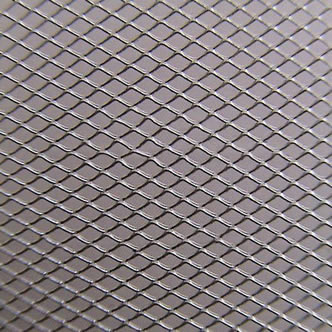 A piece of silver expanded metal mesh on the gray background.