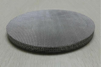 A piece of woven sintered filter disc on the desk.