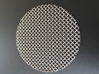 A piece of 59 mm extruder filter disc made of stainless steel 316 materials.