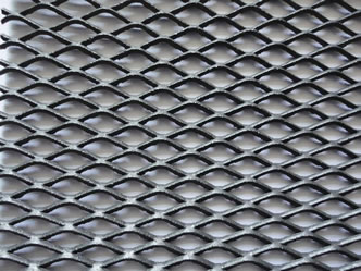 A piece of black titanium expanded meal mesh on the white background.