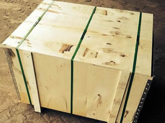 A wooden box with green packing belt on the ground.