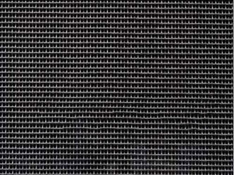 A piece of black titanium woven wire mesh on the black background.