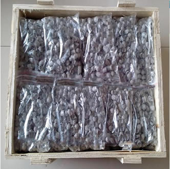 Several bags of tobacco pipe filters in a wooden box.
